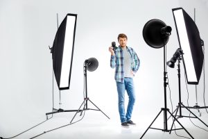 Photographer standing with photo camera