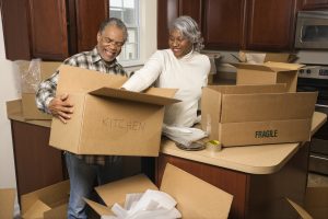couple packing boxes in kitchen