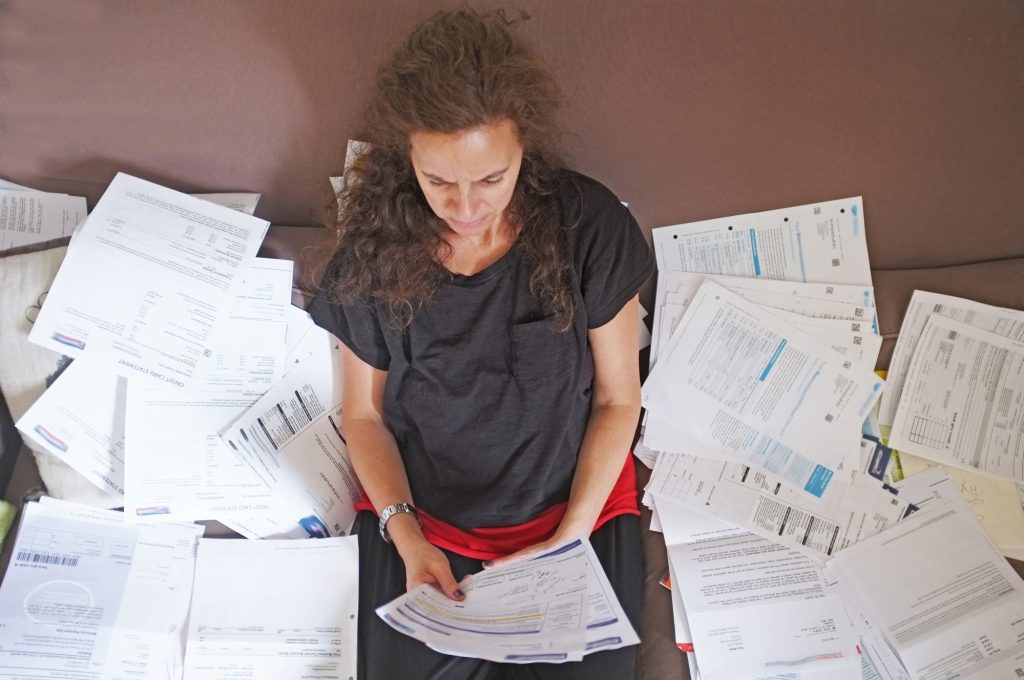 lady with pile of paperwork and bills