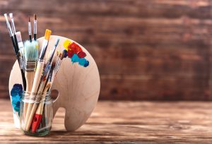 Paintbrushes in jam jar storage 